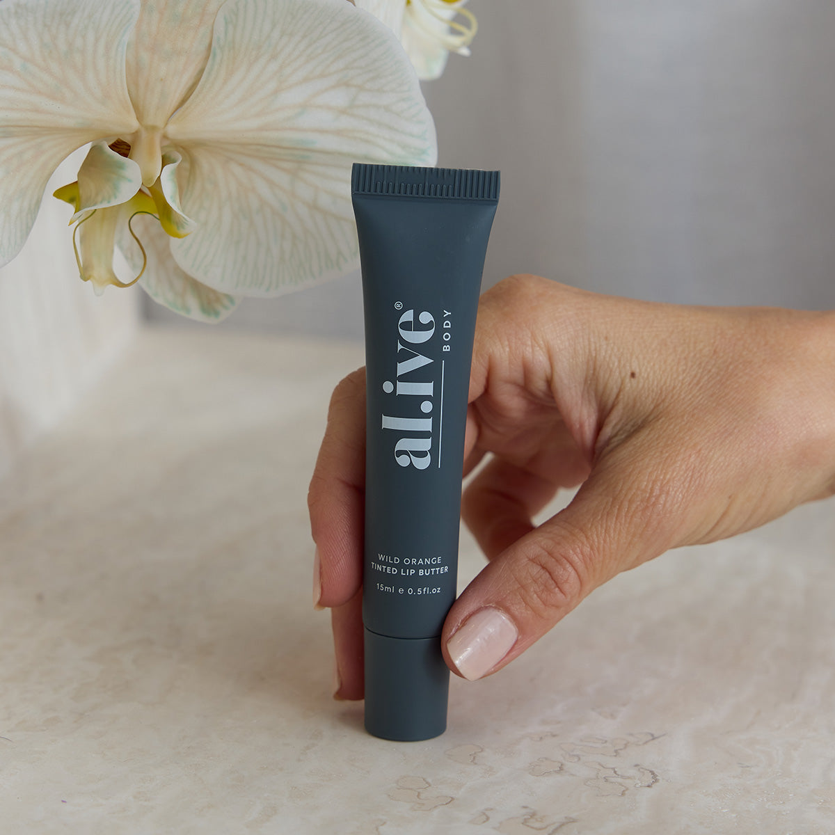 al.ive body Tinted Lip Butter Wild Orange - swatch shot