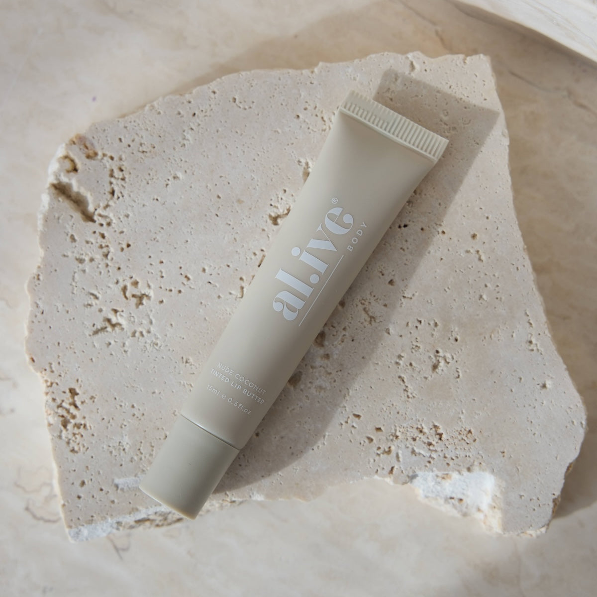 al.ive body Tinted Lip Butter Nude Coconut - product shot
