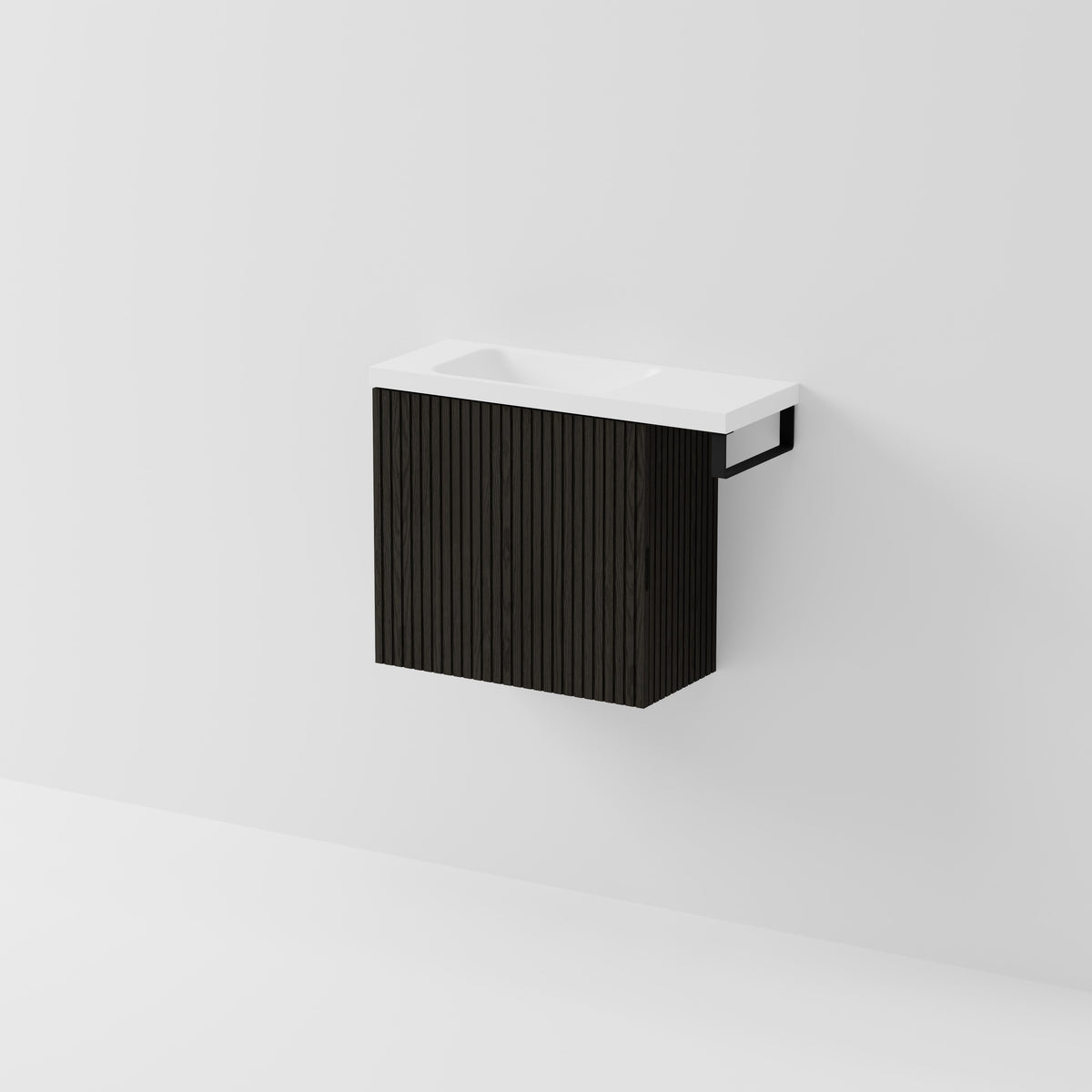 Aria 550 wall-hung WC vanity in Dark Ash timber with an offset basin and integrated Matte Black hand towel rail, shown against a white background.