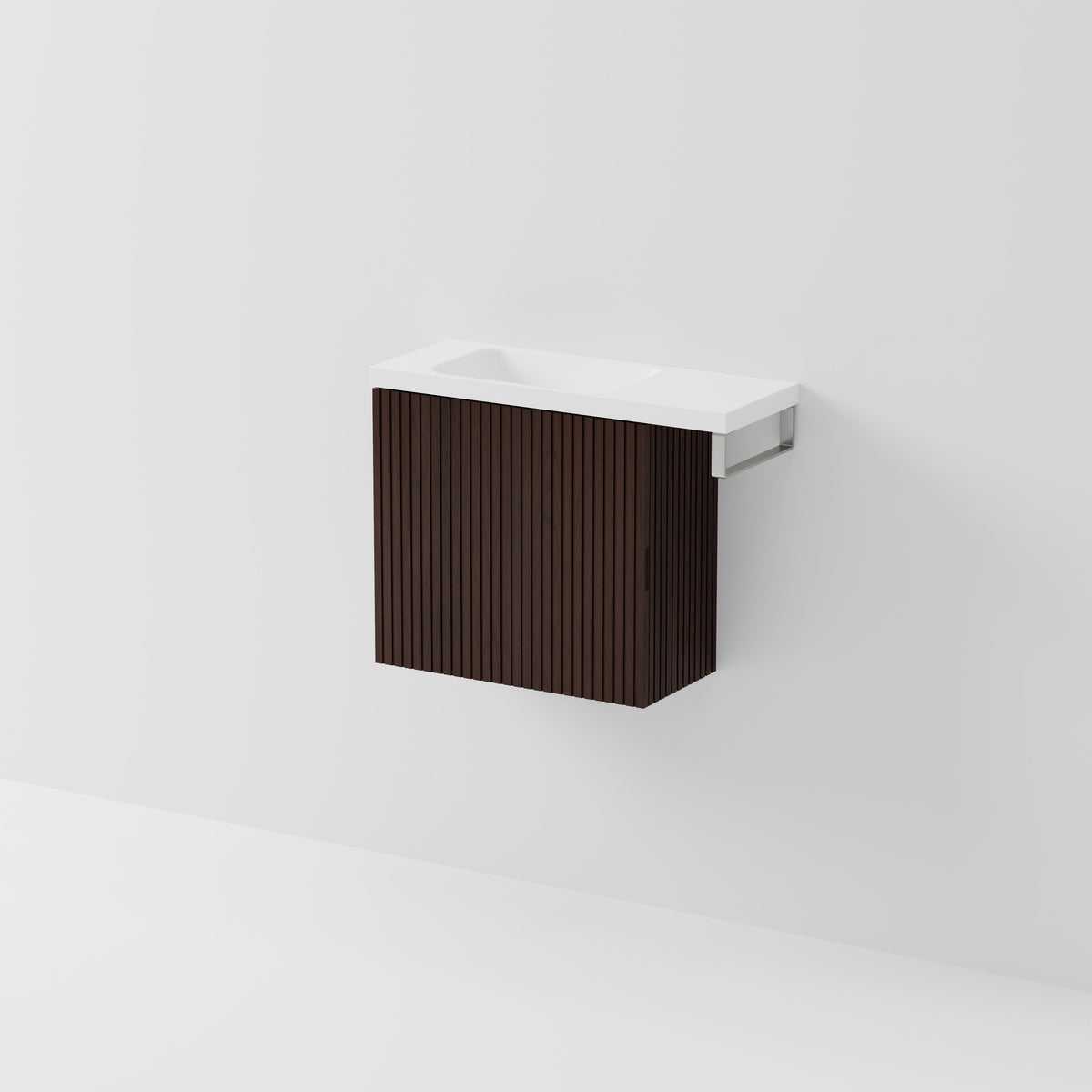 Aria 550 wall-hung WC vanity in Walnut Ash timber with an offset basin and integrated Brushed Nickel hand towel rail, shown against a white background.