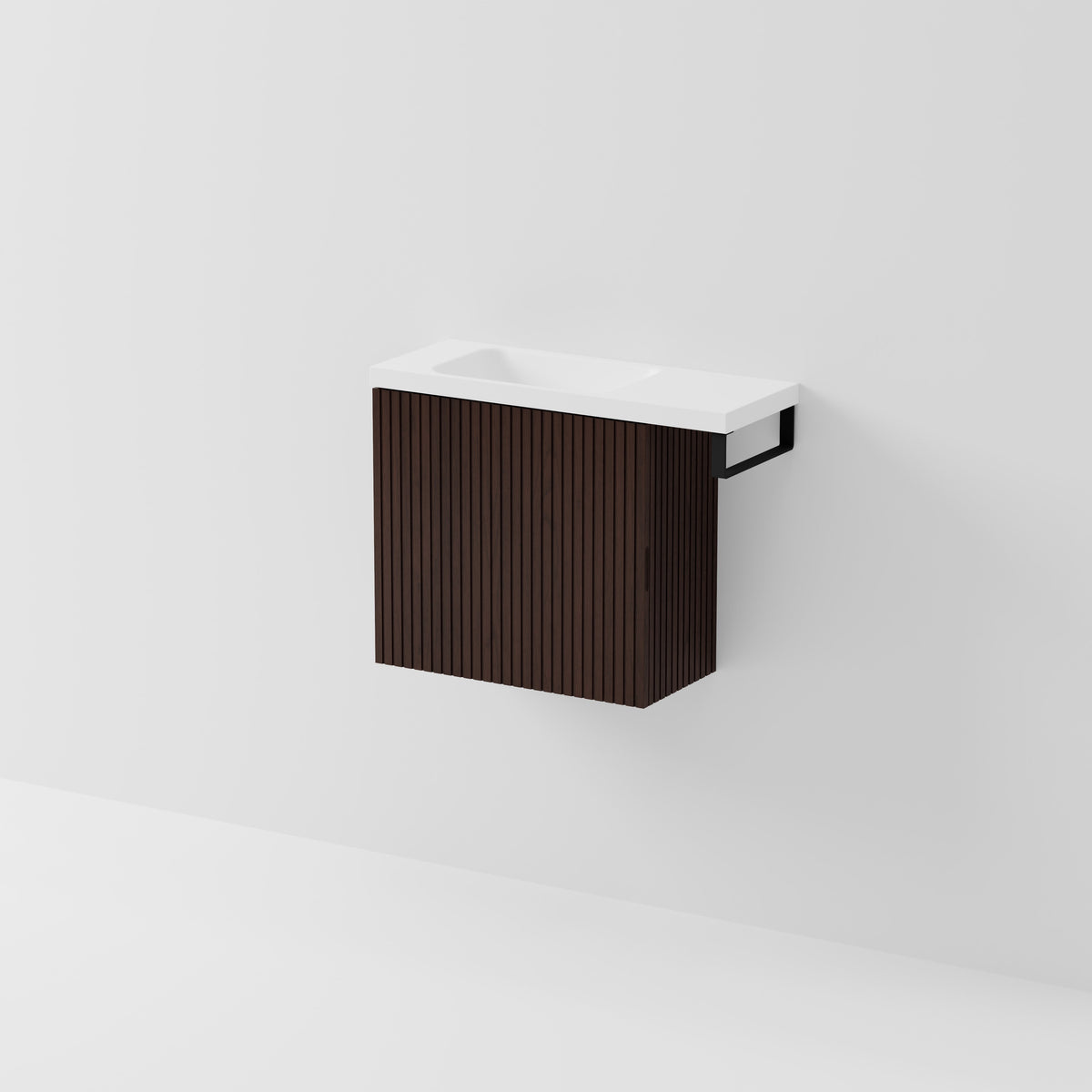 Aria 550 wall-hung WC vanity in Walnut Ash timber with an offset basin and integrated Matte Black hand towel rail, shown against a white background.
