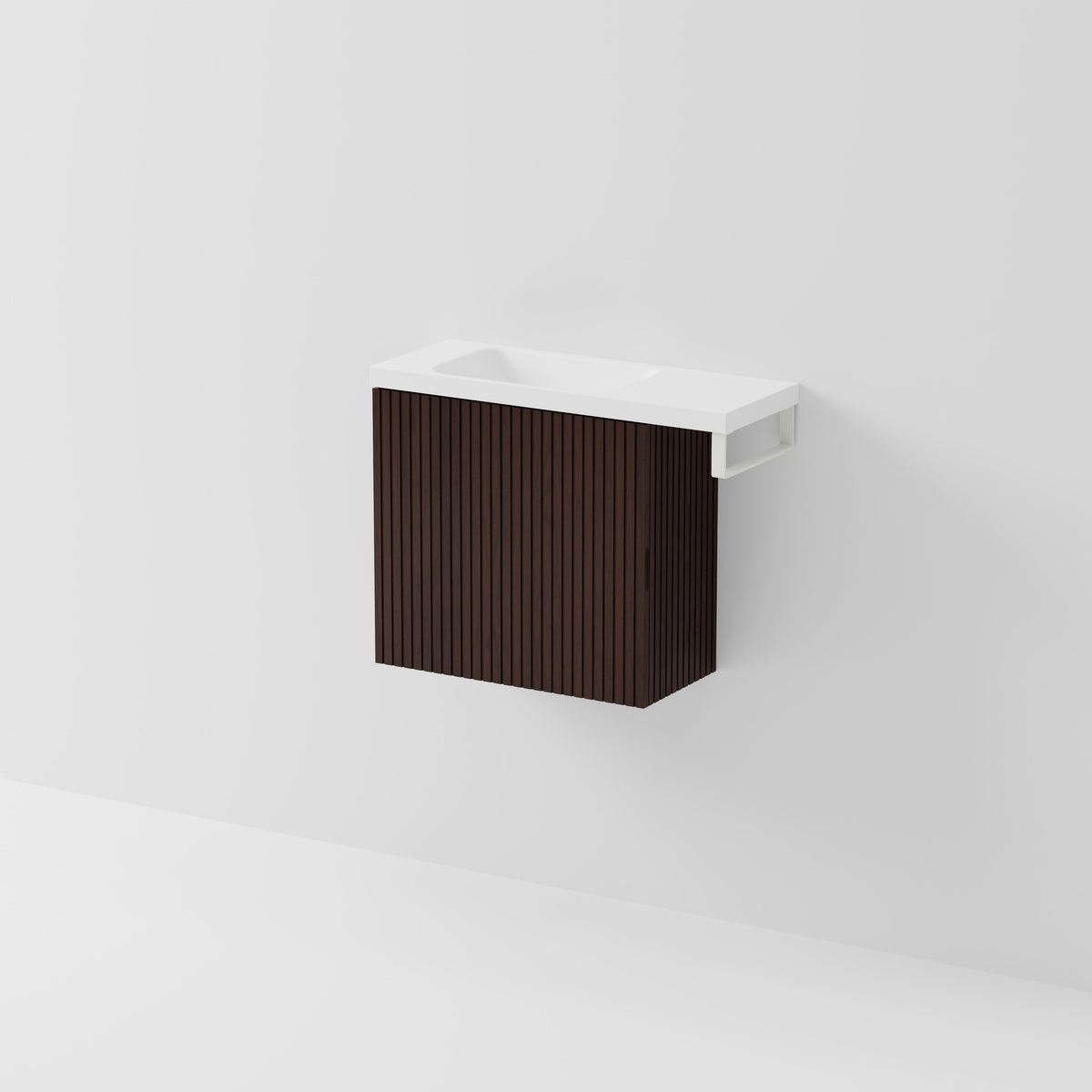 Aria 550 wall-hung WC vanity in Walnut Ash timber with an offset basin and integrated Matte White hand towel rail, shown against a white background.