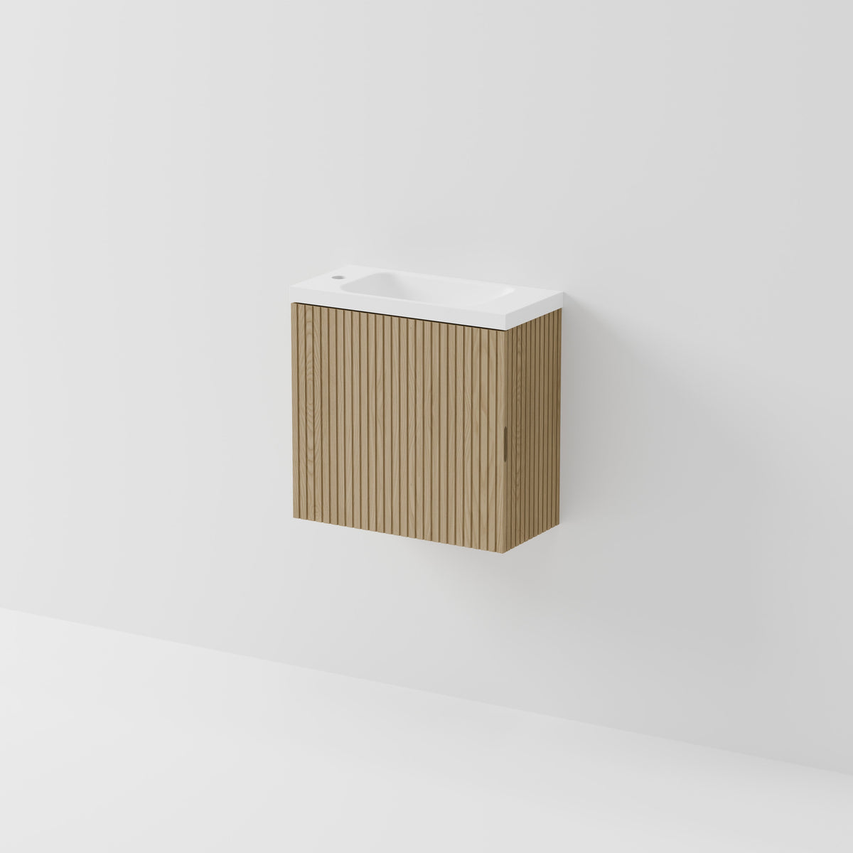 A modern wall-mounted bathroom vanity with a fluted light brown wood cabinet and a white ceramic sink basin, shown against a clean white wall.