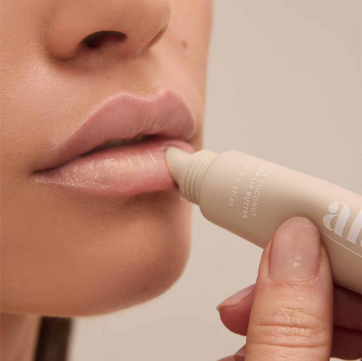 al.ive body Tinted Lip Butter Nude Coconut - lifestyle shot