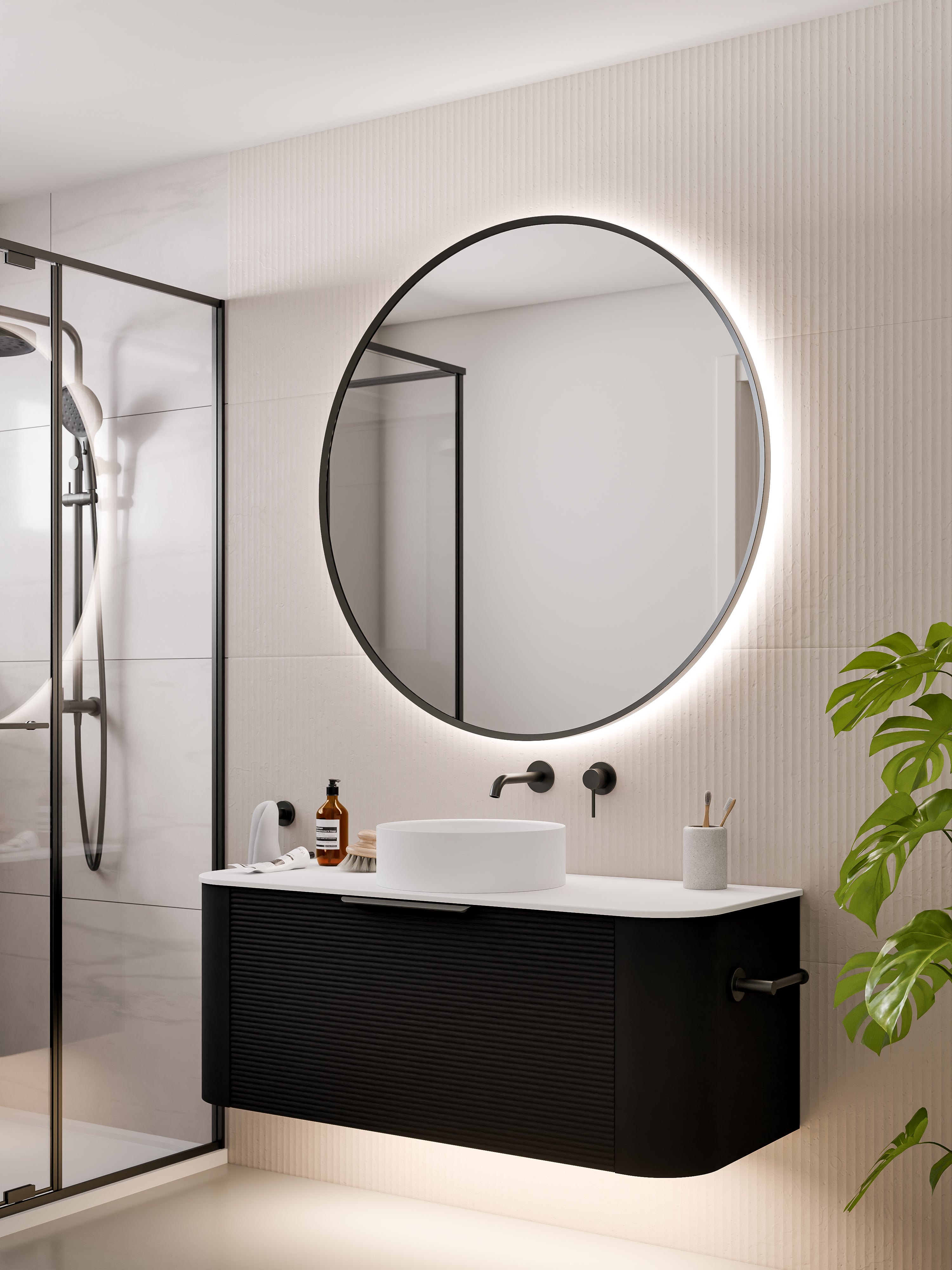 round-framed-led-mirror-in-gunmetal-with-curved-vanity-in-bathroom-setting