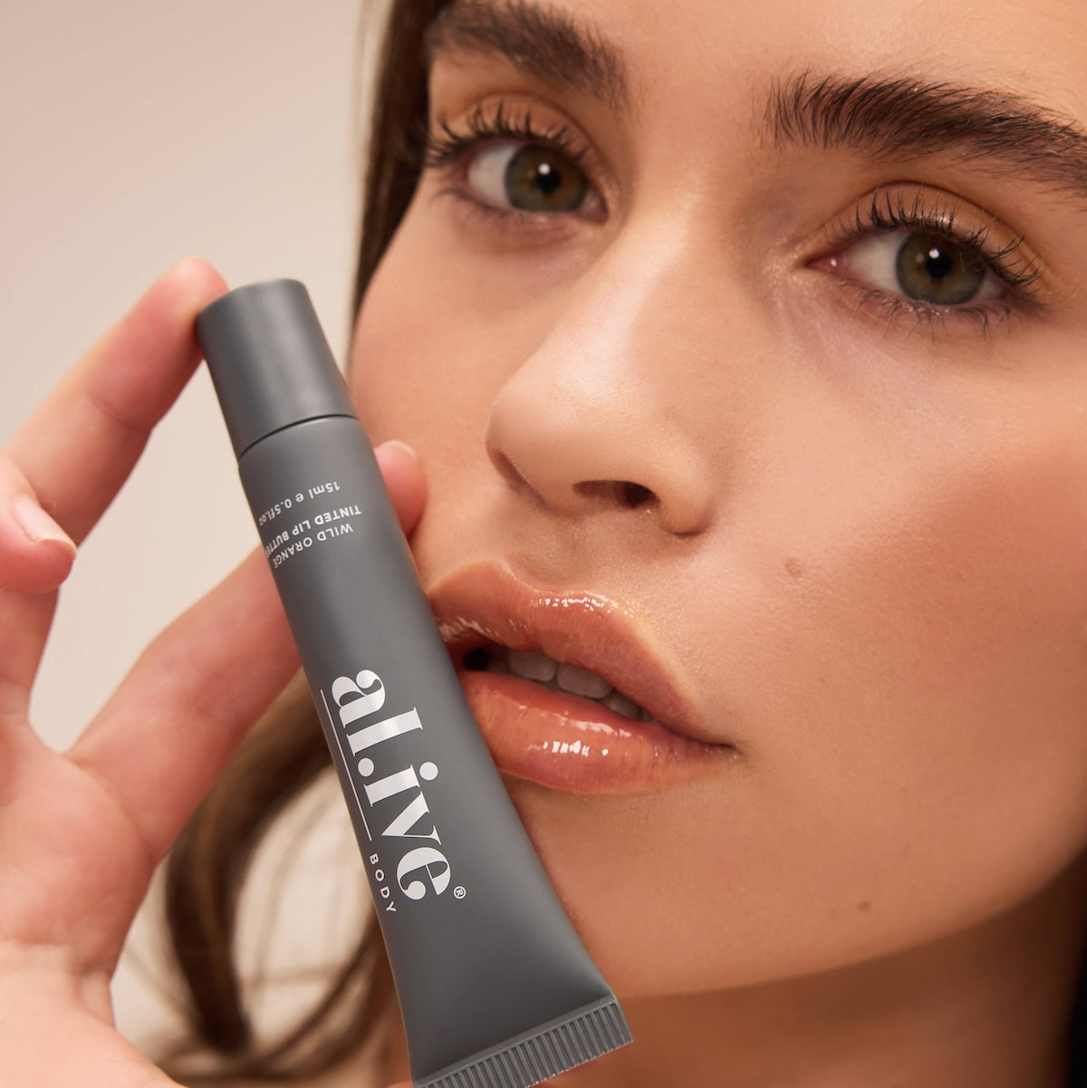 al.ive body Tinted Lip Butter Wild Orange - lifestyle shot