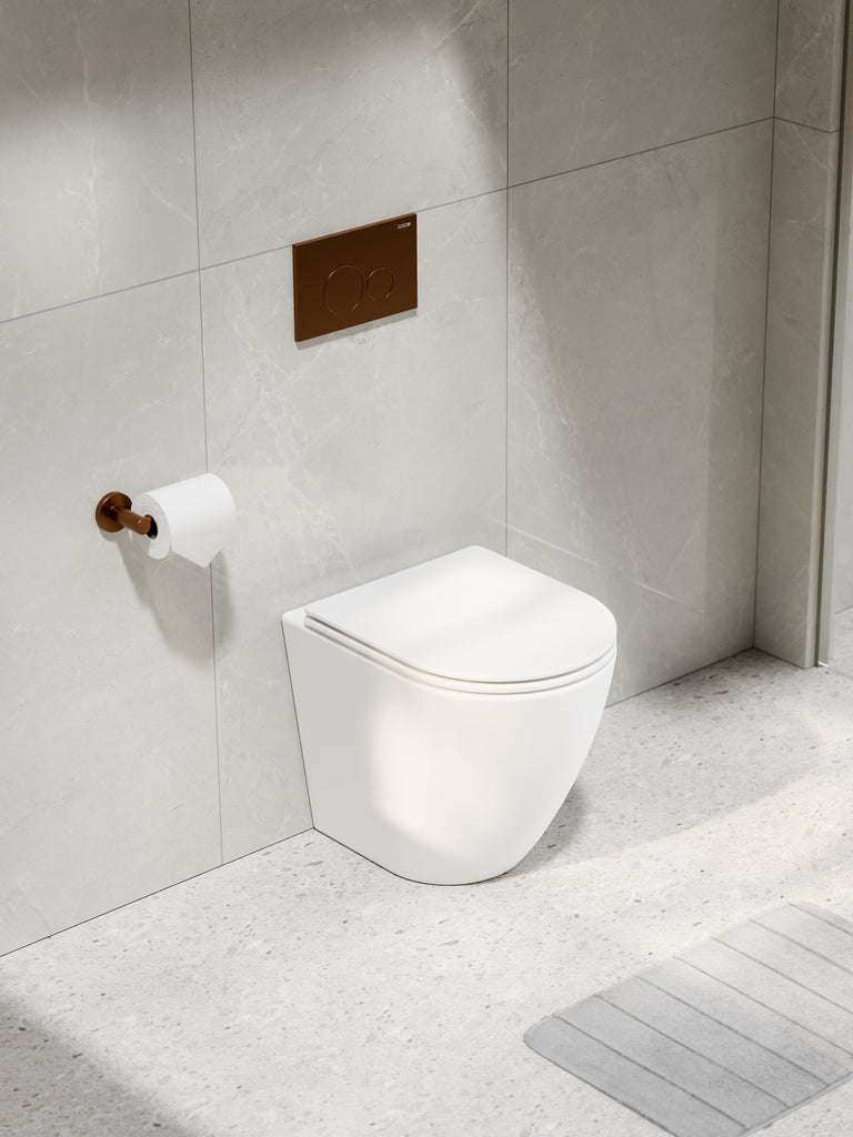 code-flow-typhoon-concealed-cistern-matte-white-toilet-suite-brushed-copper-button-tiled-wall