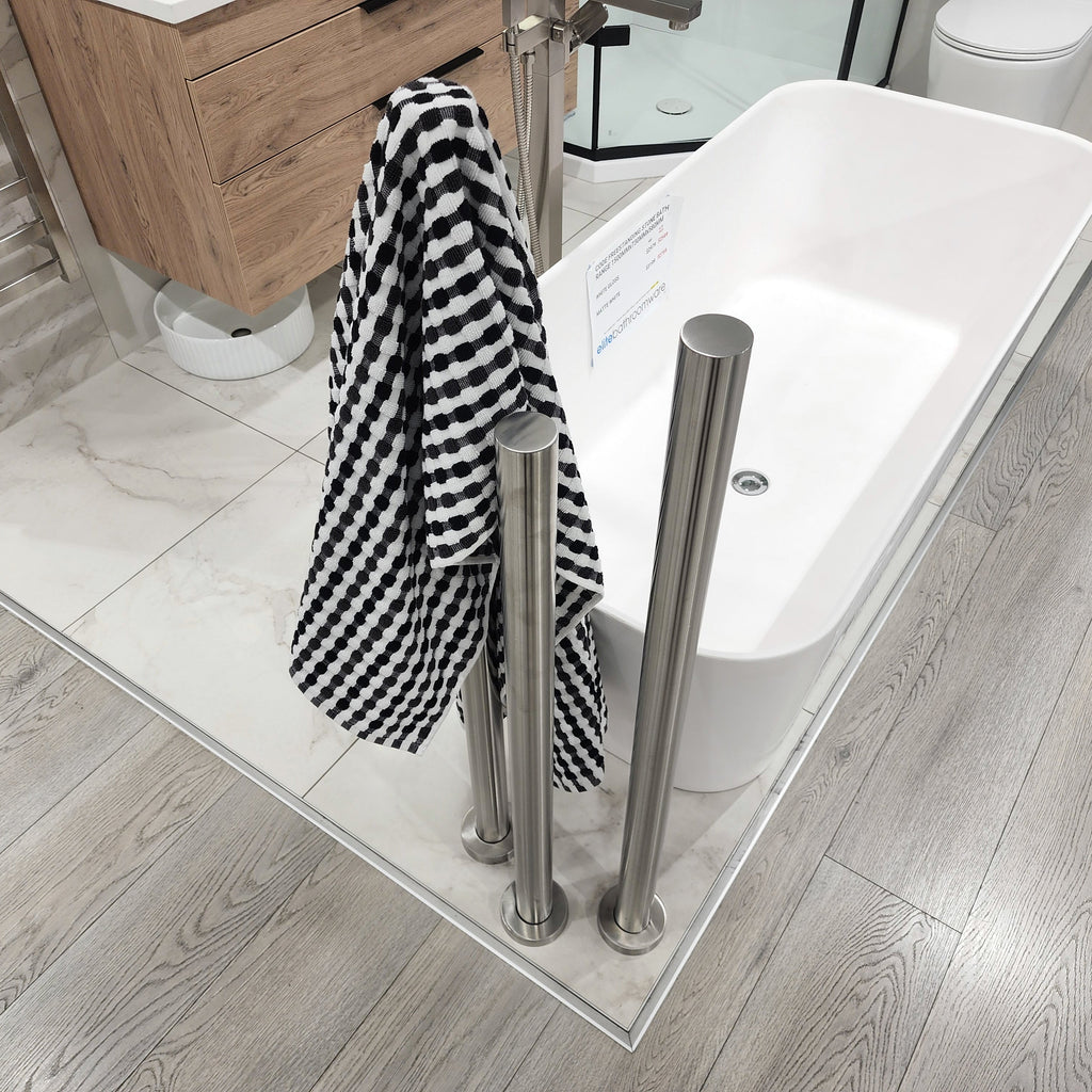 code-freestanding-heated-towel-rail-nz-brushed-nickel-in-tiled-bathroom-setting-next-to-bathtub