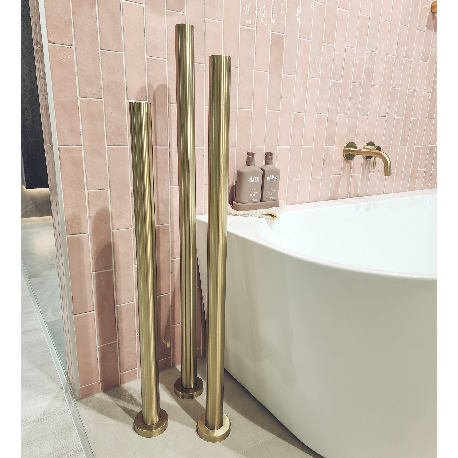 code-freestaing-heated-towel-rail-brushed-brass-in-bathroom-setting